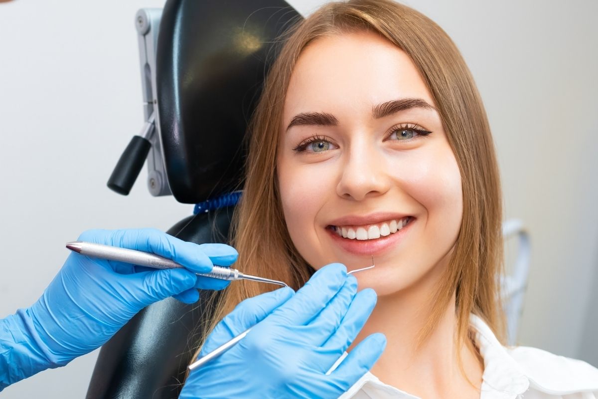 women at checkup gapped tooth explained